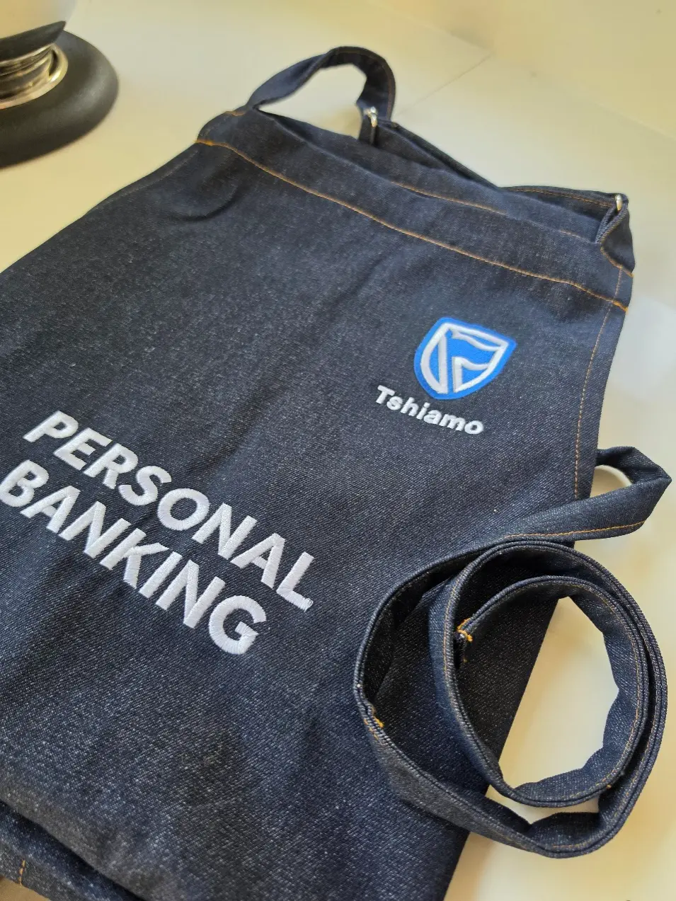 Branded apron for a corporate cooking event at The Cookery