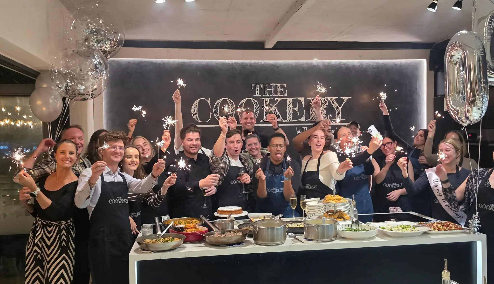 Corporate group celebrating after a team building cooking class